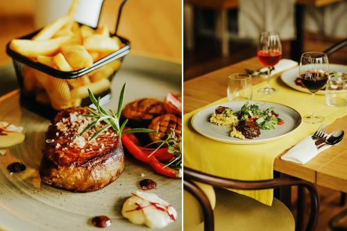 a table with a plate of food and glasses of wine at Poznań West Hotel - Airport in Poznań