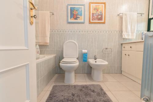 een badkamer met een toilet en een wastafel bij Carvoeiro, 2BR Pestana Gramacho Golf Apartment in Estômbar