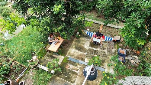 an overhead view of people sitting at tables in a garden at Vườn Nhà Ngoại Garden Homestay in Cu Chi