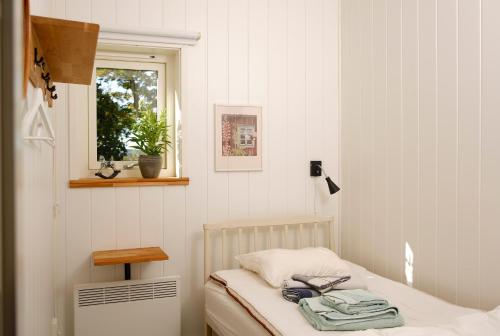 a small room with a bed with a window and a window at Övre Jäder 1 - Jönåker in Jönåker