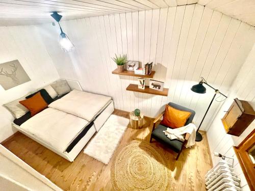 Cette petite chambre comprend un lit et une chaise. dans l'établissement Serpolet - Chalet 4 personnes - Sauna, à Leysin