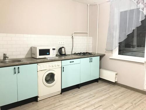 PashkovskiyにあるApartments on Sormovskayaのキッチン(洗濯機、電子レンジ付)