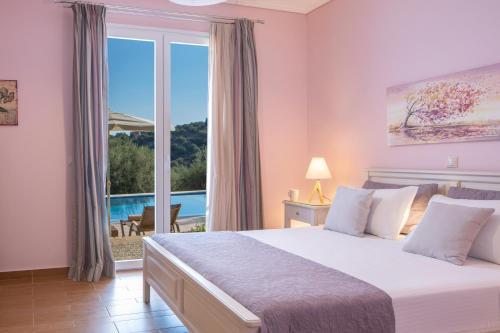 a bedroom with a large bed and a large window at Villa Phaedra, Inoro Villas in Katouna