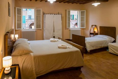 Cama o camas de una habitación en In Collegiata