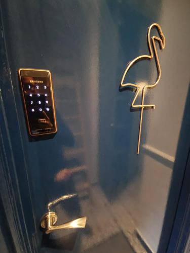 a door with a key on it with a cross on it at Flamingo Lodge in Torquay