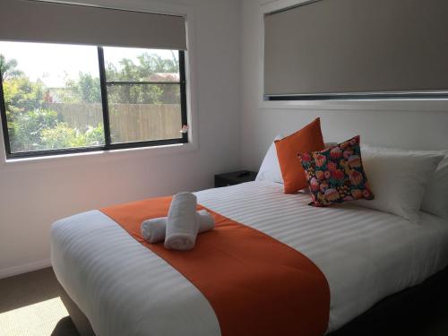 a bedroom with a bed with a stuffed animal on it at Fishing Haven Holiday Park in Palmers Island