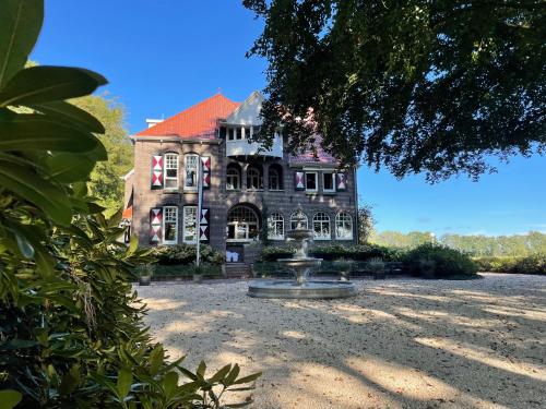 a large house with a fountain in front of it at Villa Rozenhof in Almen
