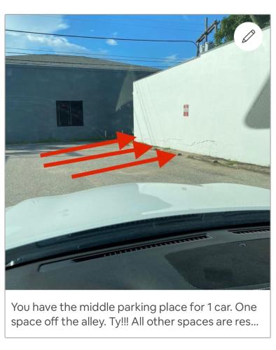 a car parked in a parking lot next to a wall at The Pink Room at Emily's On The Island in Galveston