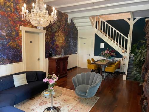 a living room with a blue couch and a table at Villa Rozenhof in Almen