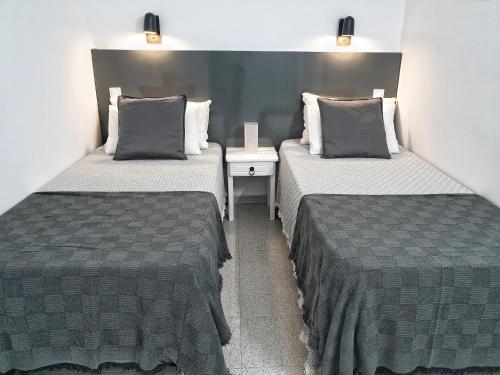 two twin beds in a room with one sidx sidx sidx at Tamaran 106 Vv Maspalomas in Playa del Ingles