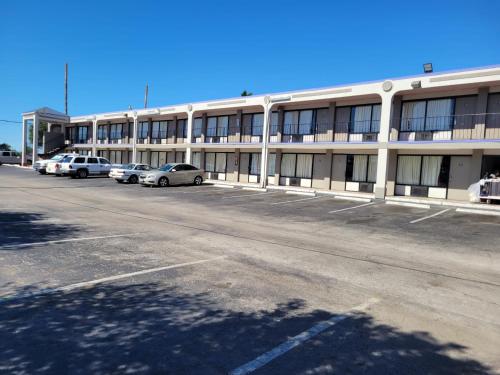 an empty parking lot in front of a building at Knights Inn San Antonio near Frost Bank Center in San Antonio
