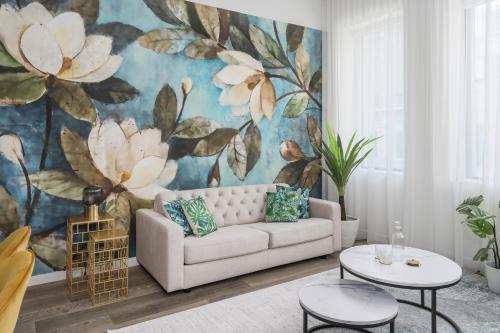 a living room with a couch and a flower mural at Bakan - Sainte Catherine in Montréal