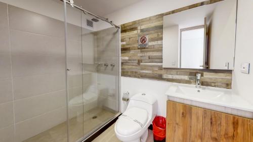 a bathroom with a toilet and a sink and a shower at Terrazas in Bogotá