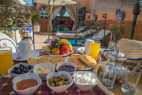 a table topped with plates of food and drinks at New Bahia in Marrakech