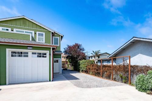 a green house with a garage at Beach Town Home - Walk to Beaches Downtown Activities and so much more in Half Moon Bay