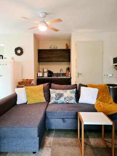 a living room with a couch with colorful pillows at GREAT CANAL STUDIO - AC, Water view & Free parking in Amsterdam