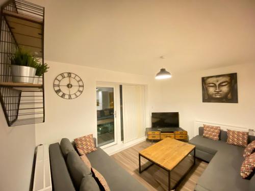 a living room with a couch and a table at 3 Bedrooms double or single beds, 2 PARKING SPACES! WIFI & Smart TV's, Balcony in Portsmouth