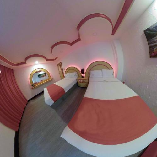 Una cama o camas en una habitación de Hotel Coacalco