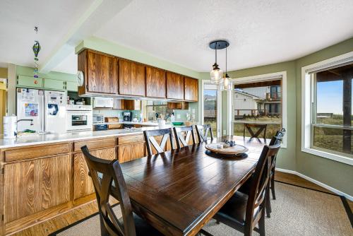 a kitchen with a long wooden table and chairs at Seabird Lodge in Rockaway Beach