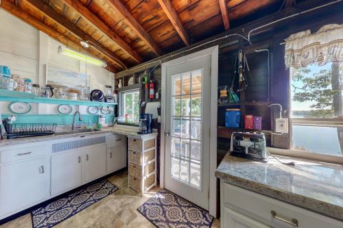 a kitchen with blue walls and white cabinets at Saganook in Brunswick