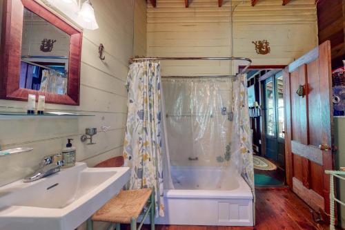 a bathroom with a tub and a sink at Saganook in Brunswick