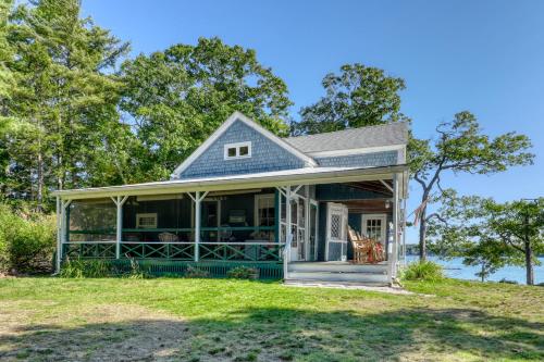 a house with a wrap around porch on a lawn at Saganook in Brunswick