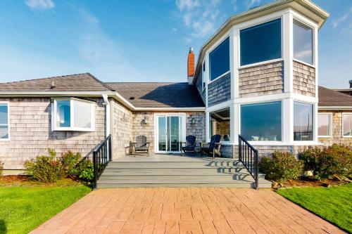 a large house with a porch with glass windows at Yorkshore in Seaside