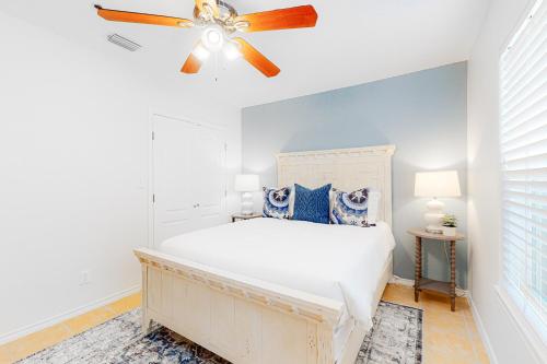 a bedroom with a bed and a ceiling fan at Star Beach Side Condominiums #105 in South Padre Island