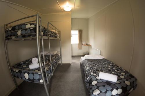 a small room with two bunk beds in it at Kings Ohakune in Ohakune