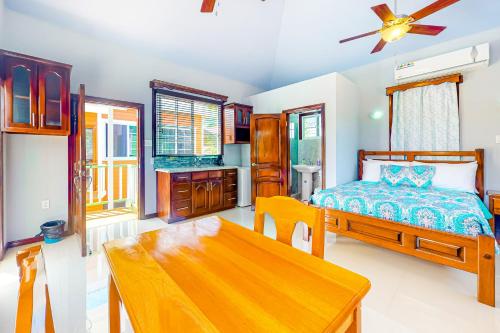 ein Schlafzimmer mit einem Bett und einem Tisch darin in der Unterkunft Kiara at Hummingbird Estate Gold Standard Certified in Dangriga