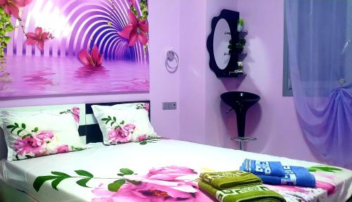 a bedroom with a bed with flowers on it at Perfect Suites in Neos Marmaras