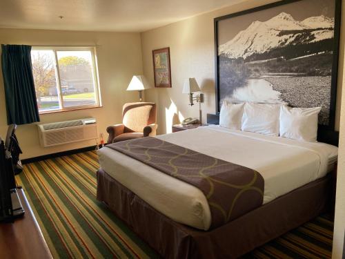 a hotel room with a large bed and a window at Super 8 by Wyndham Windsor in Windsor