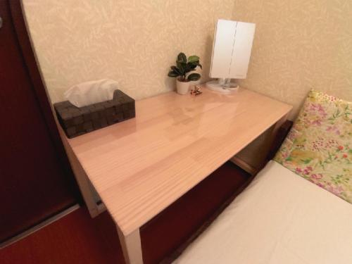 a wooden desk with a lamp and a plant on it at Woman Only Guesthouse Nanohana (Female only) in Kyoto