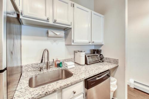 a kitchen with a sink and a microwave at The Mill #210 in Ludlow