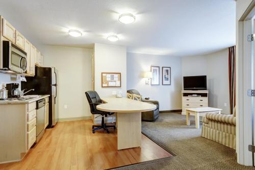 a kitchen and living room with a table in a room at Candlewood Suites Paducah by IHG in Paducah