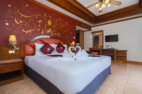 a bedroom with a large white bed in a room at Memory Karon Resort in Karon Beach
