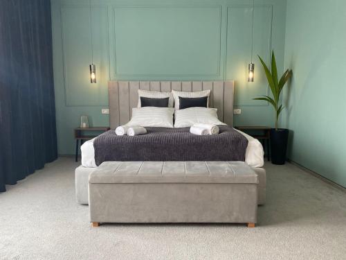 a bedroom with a large bed with a large ottoman at CoolKush Boutique in Constanţa