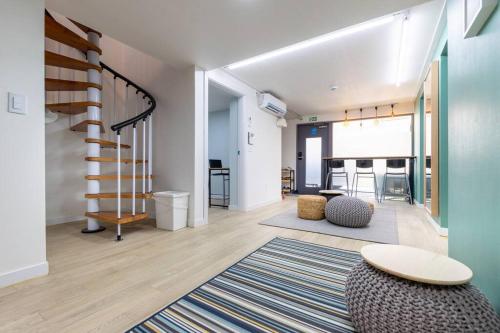 a living room with a staircase and a rug at Luda house in Seoul