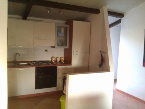 a kitchen with white cabinets and a stove top oven at 1st floor apartment in villa Falari near the in Avola