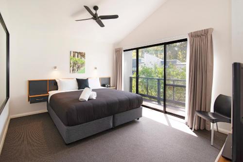a bedroom with a bed and a large window at Margs Central Stay in Margaret River Town