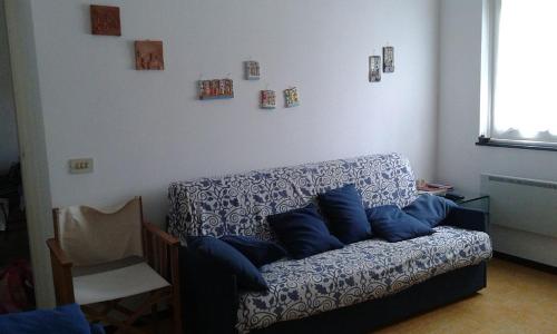 a living room with a couch with blue pillows on it at La Terrazza sul Mare in Levanto