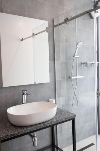 a bathroom with a white sink and a shower at Rest&Ski Spa Resort in Bukovel