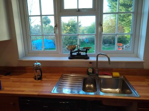 a kitchen counter with a sink and a window at Worfield in Hereford