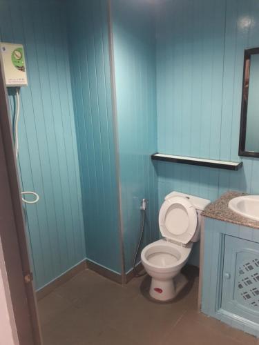 a blue bathroom with a toilet and a sink at Momento Resort in Pattaya South