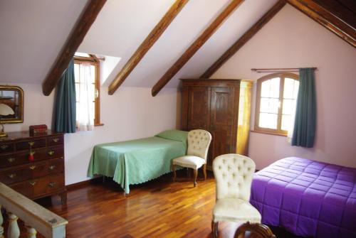 a bedroom with a bed and a dresser and windows at B&B Vecchia Suppenna in Andria