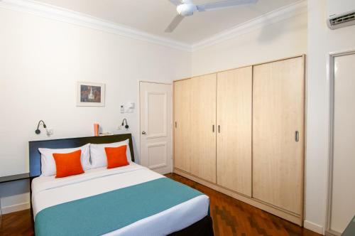 a bedroom with a bed and wooden cabinets at Wedgewood Residences in Kuala Lumpur