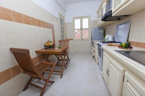 a small kitchen with a table and chairs and a stove at Grand Residence in Phnom Penh