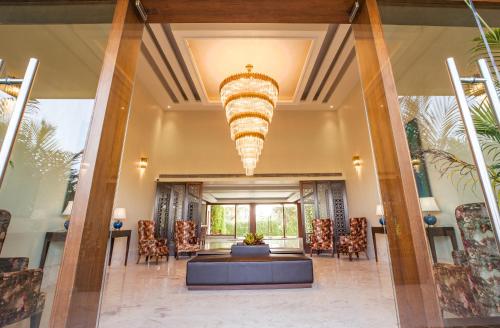 a large lobby with a large chandelier at The Lalita Grand Mathura- Vrindavan in Mathura