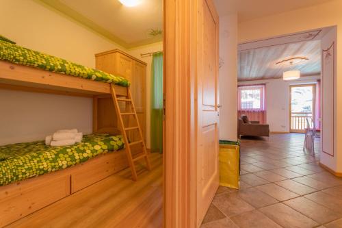 a room with a bunk bed and a ladder at Villa Edelweiss in Alleghe