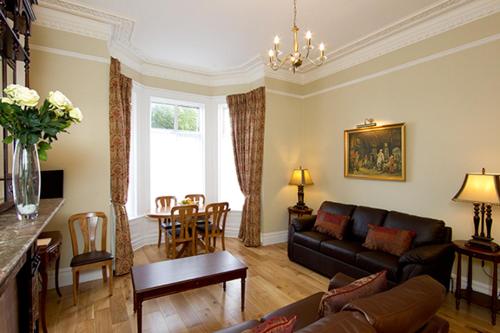 a living room with a couch and a table at Glencourt Apartments in Dublin
